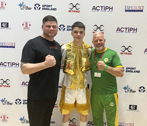 A Cricklewood boxer celebrating with the coaching team